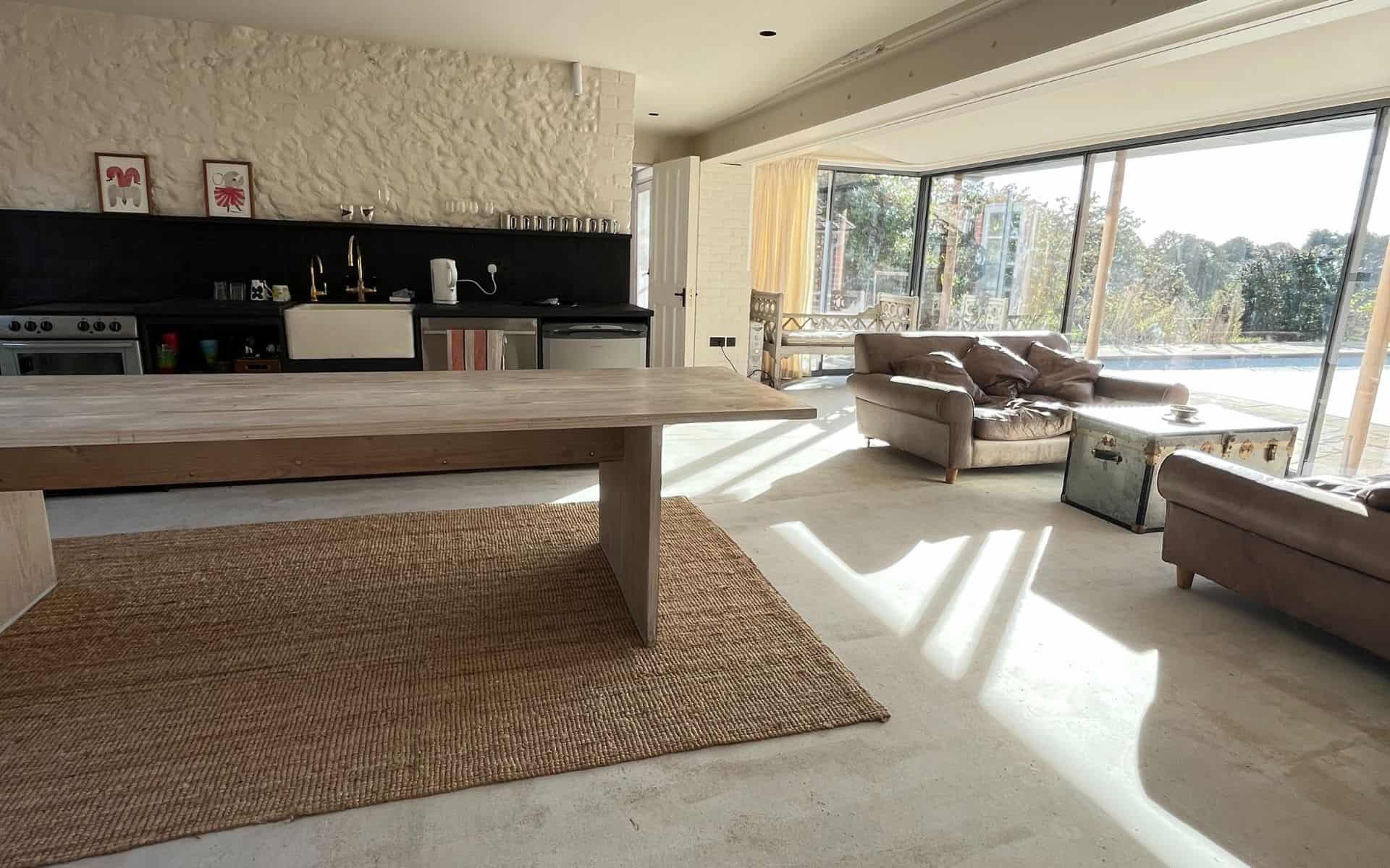 Modern living space in The Stables, Barn Drift, Norfolk, with large windows and natural light.