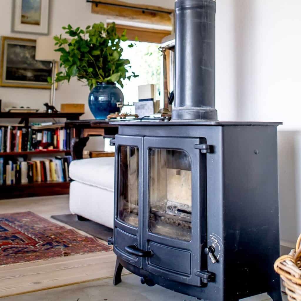 Modern black wood-burning stove in a cosy Norfolk living room.