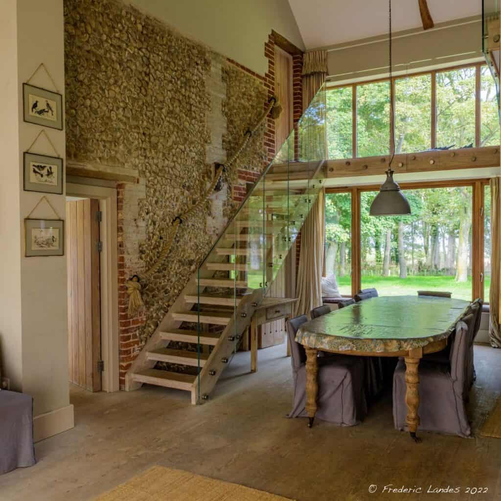 Luxury Norfolk accommodation space featuring glass staircase, vintage accents, and scenic views in Norfolk, UK.