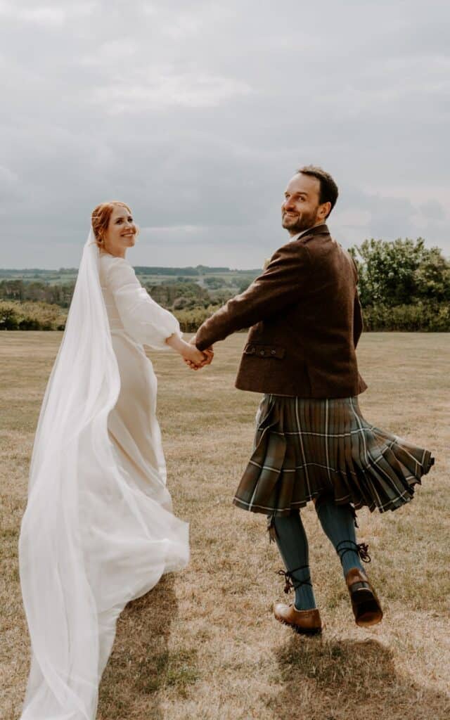 Romantic couple dancing outdoors at small wedding venue in Norfolk, UK.