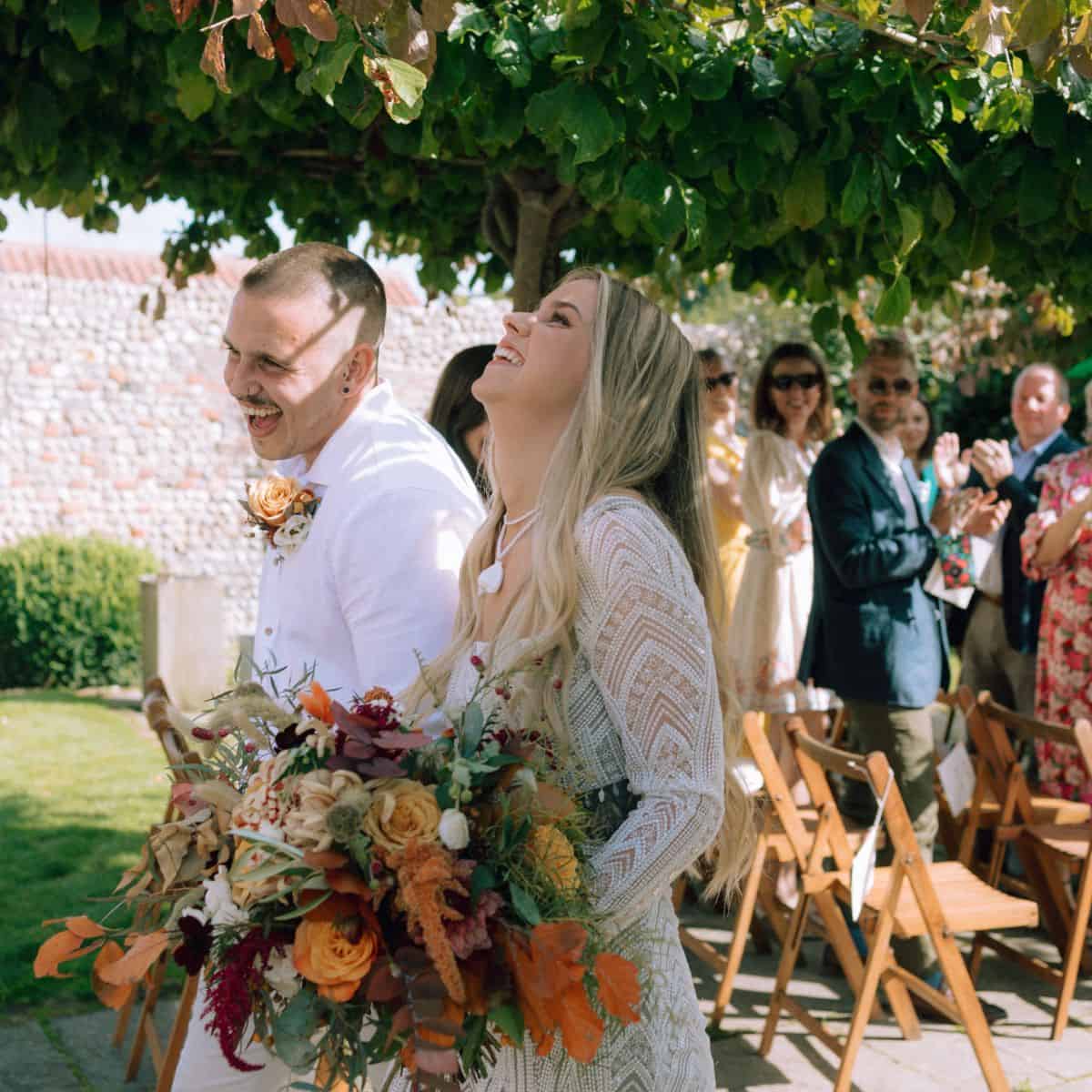 Beautiful wedding ceremony at Barn Drift Norfolk with outdoor garden setting.